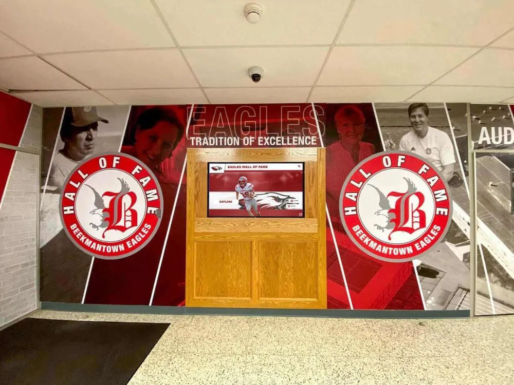 Comprehensive basketball hall of fame wall display with digital and traditional elements