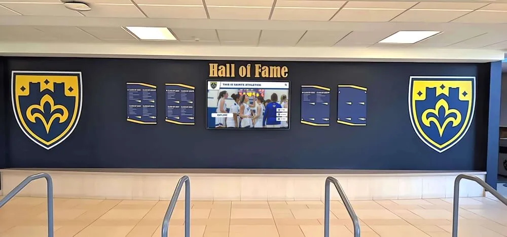 Traditional hall of fame wall with shields and digital screen