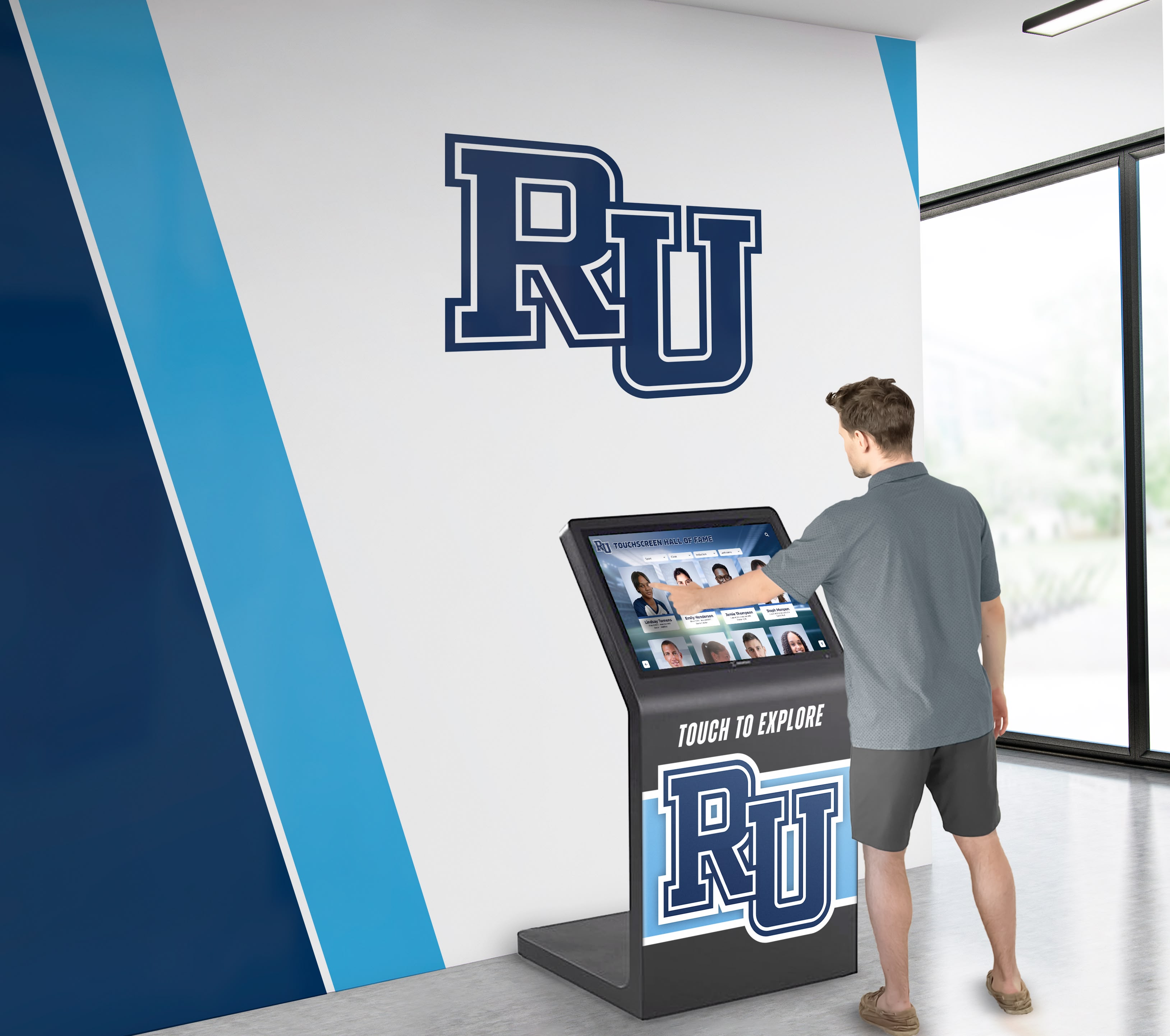 Alumni exploring business leader profiles on interactive display